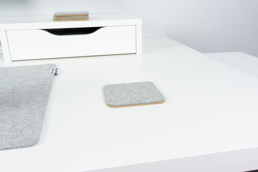 Grey merino wool coaster on desk, rounded corners - BeaverPeak