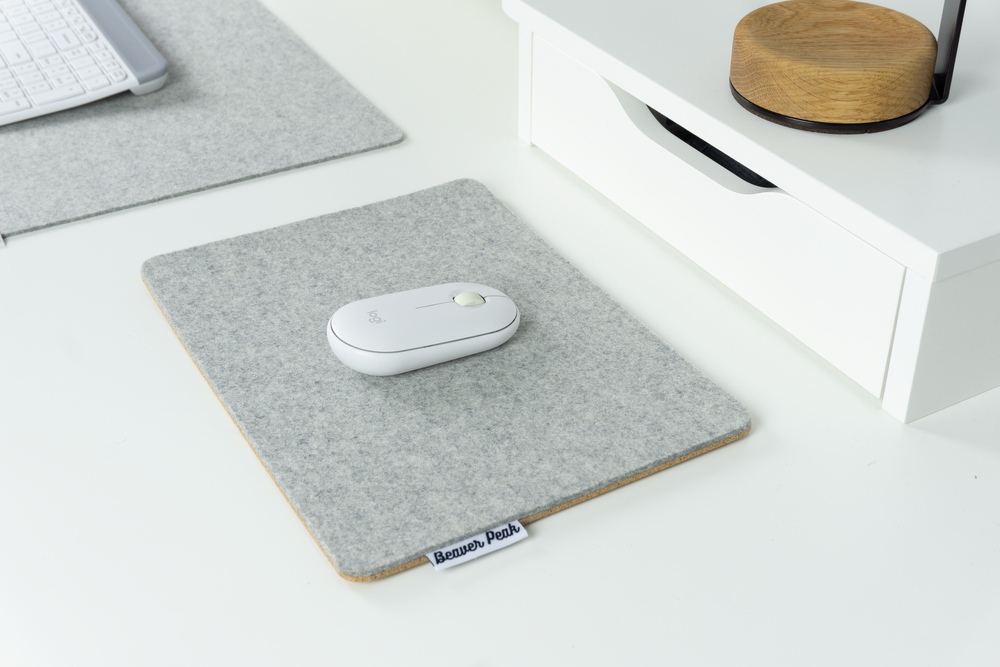 Grey merino wool felt mouse pad on white desk with matching grey wool felt desk mat in background