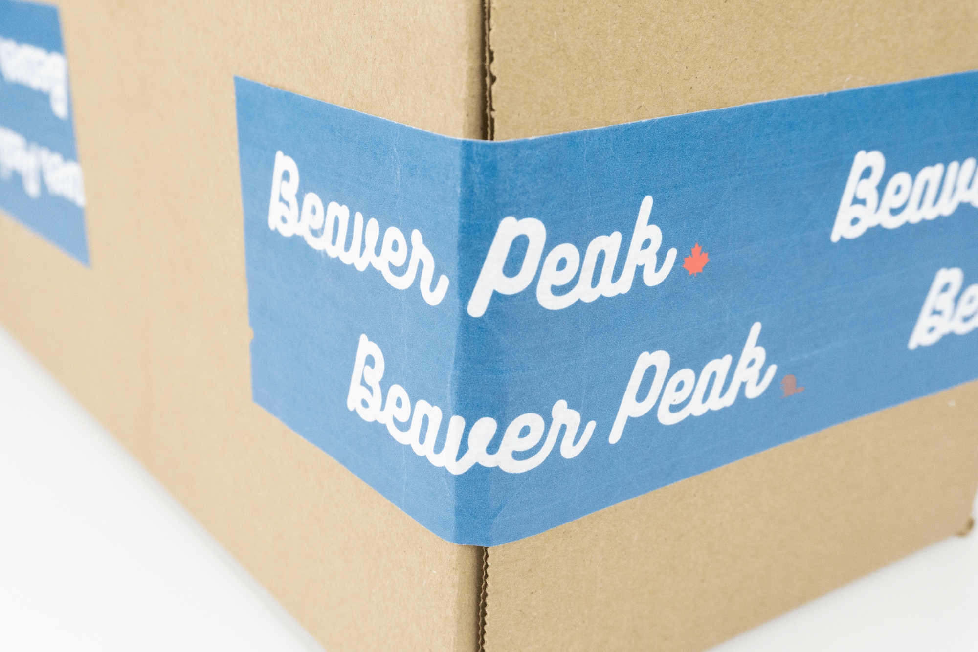 Closeup of packaging box with blue beaverpeak tape.