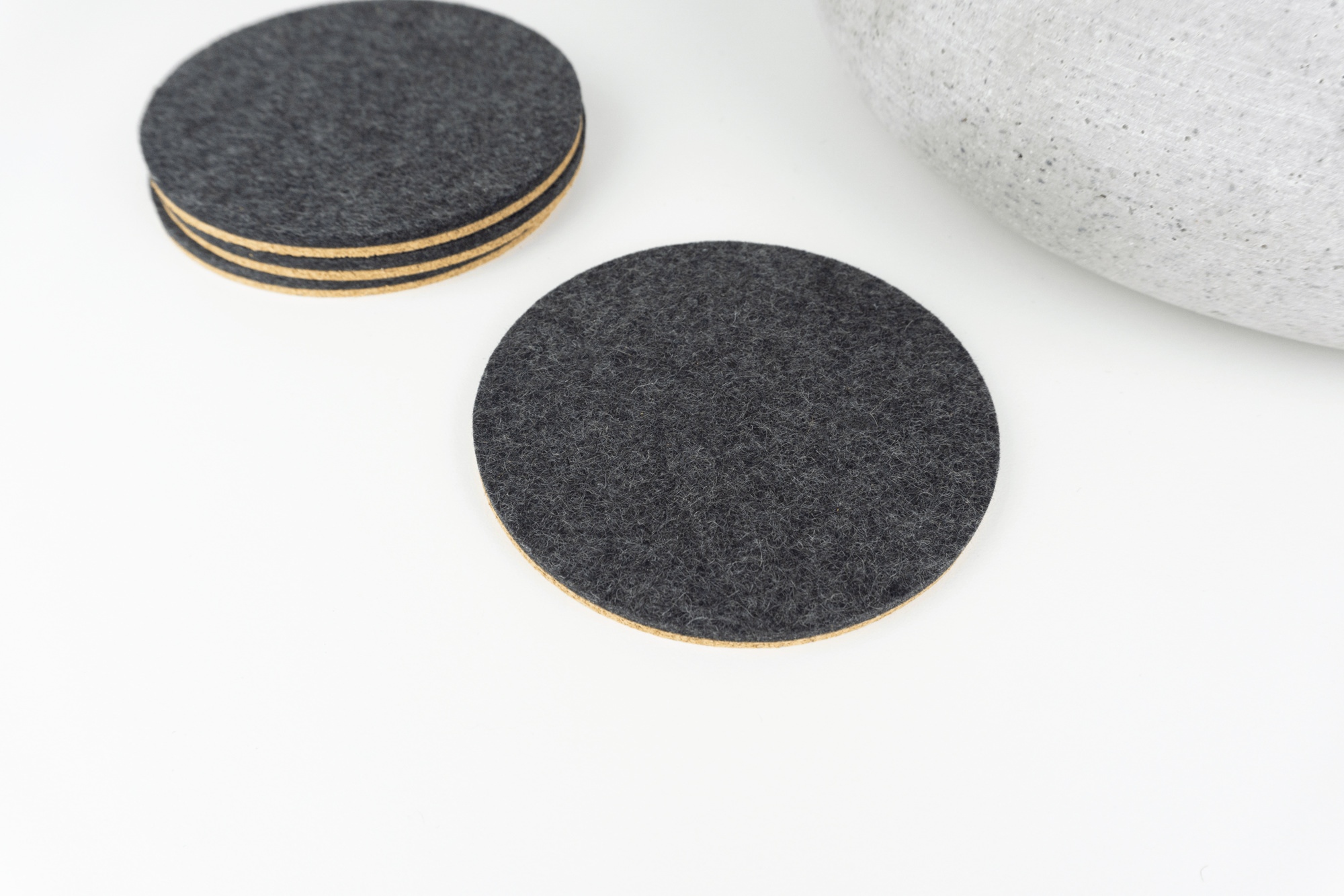Our Black circle coasters set shown on a white coffee table.