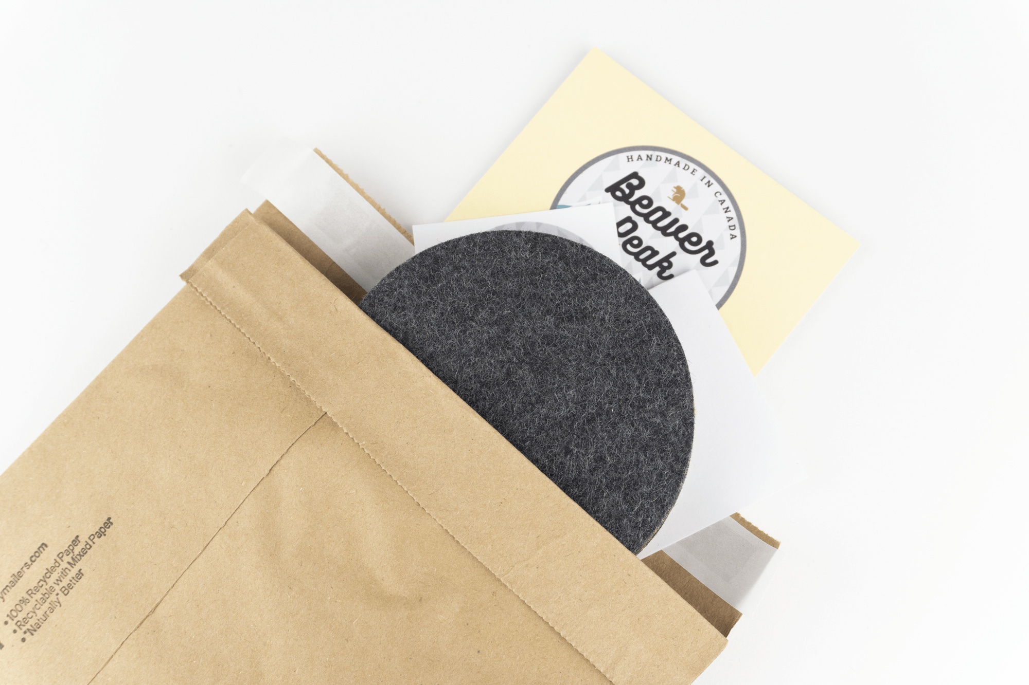 The recyclable kraft paper packaging we use for our circular desk coasters shown up close.