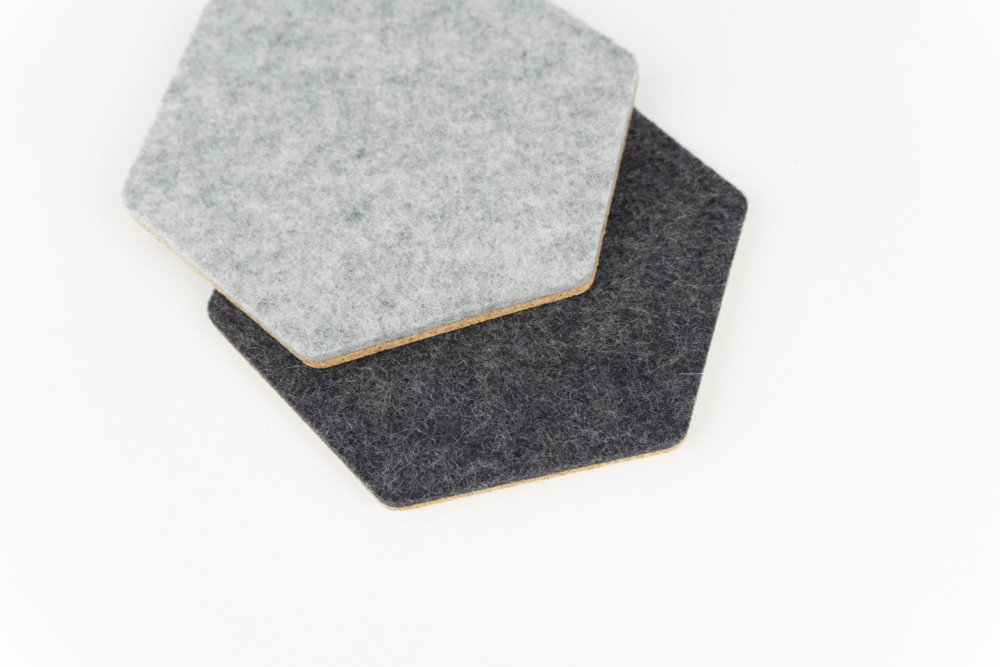 Colour comparison between our black and grey wool hexagonal coasters.