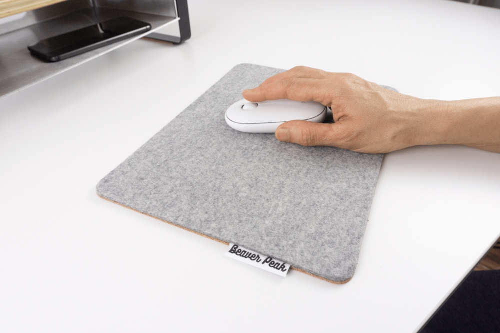 Grey wool felt mouse pad with hand using white mouse.