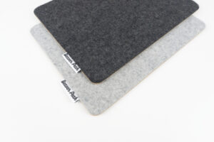 Merino wool felt mouse pad colour comparison, showing grey mouse pad against black mouse pad.