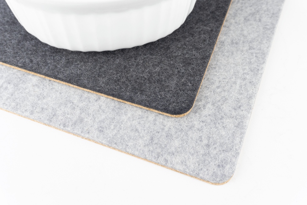 Comparison of grey vs black merino wool felt trivets.