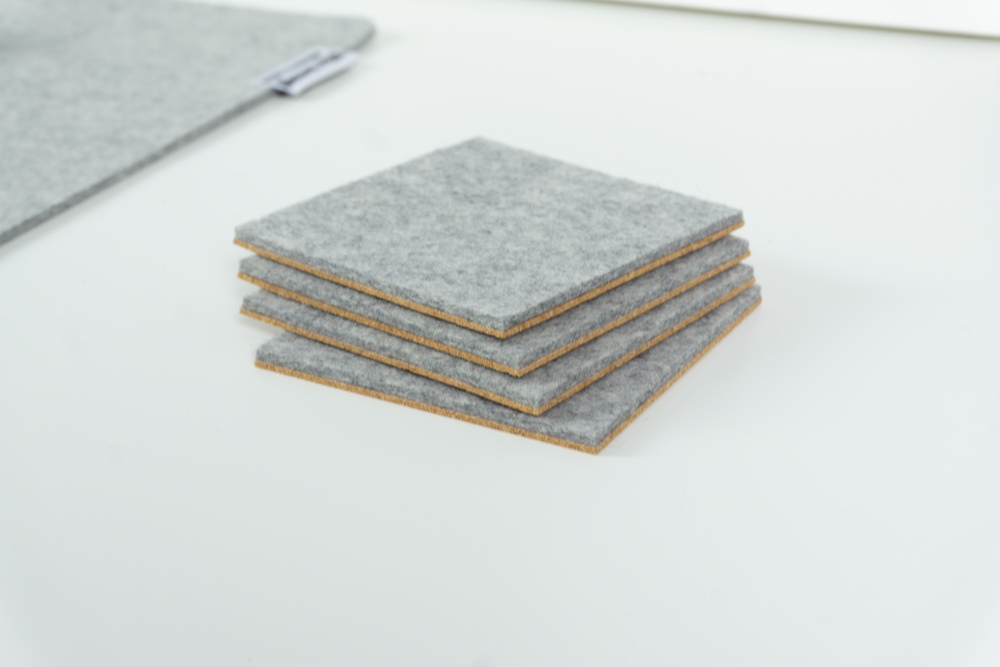 Merino wool coaster set of 4 in grey felt with square corners.