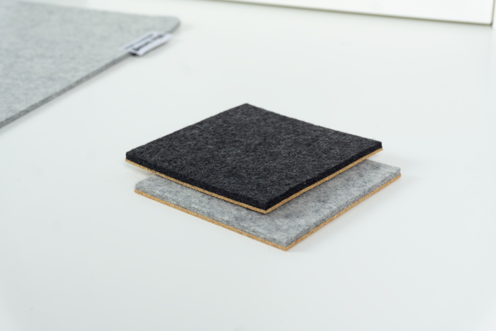 Comparison of black and grey merino wool felt coasters with square corners.